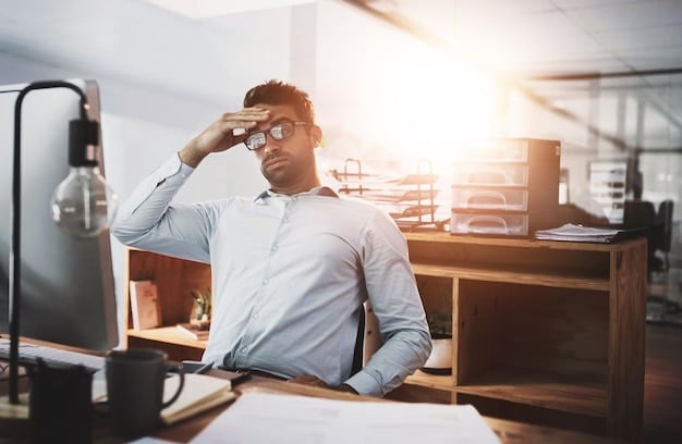 A concerned worker sitting at a desk, holding their head in their hands, with blurred documents and office supplies around. Soft, diffused lighting and a focus on the worker's face convey a sense of stress and inability to work.