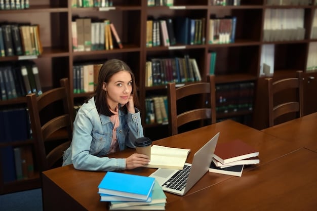 A focused student is studying at a desk in an American university library, with books and a laptop open, bathed in natural light from a large window. The general feel is studious and diligent, the image emphasizes the effort and academic dedication.